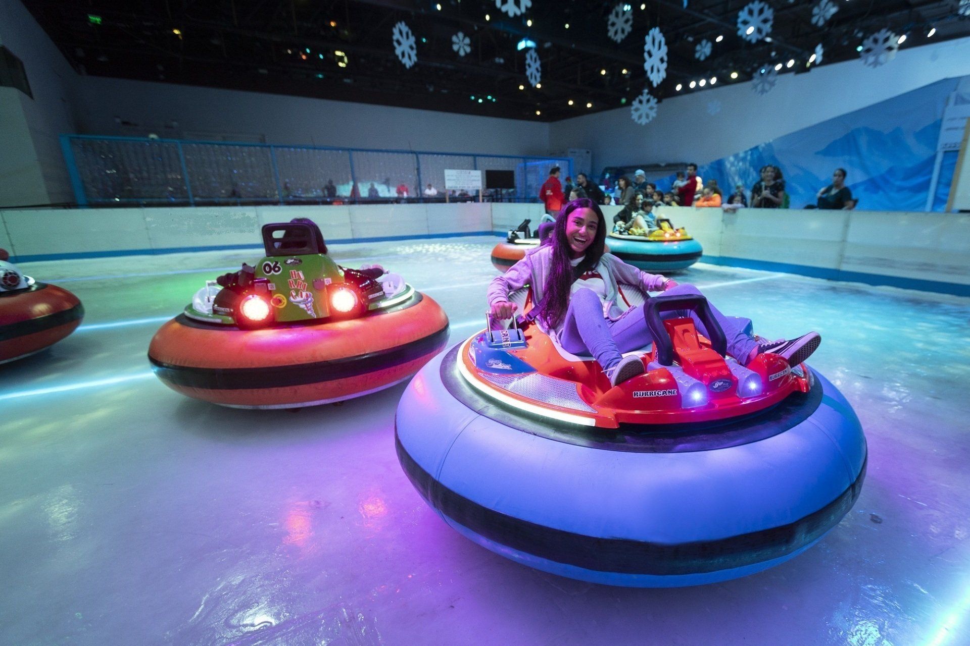 Two amazing ice bumper cars on an ice rink.