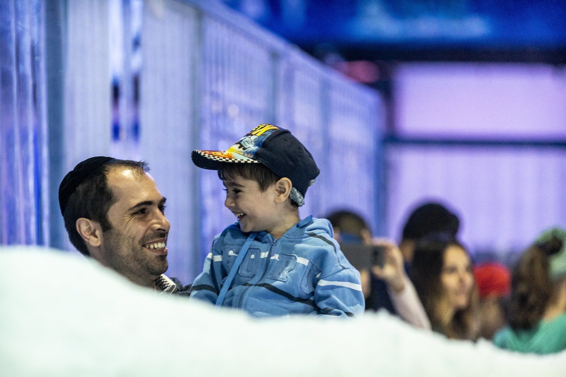 Father & son with huge smiles in snow playground