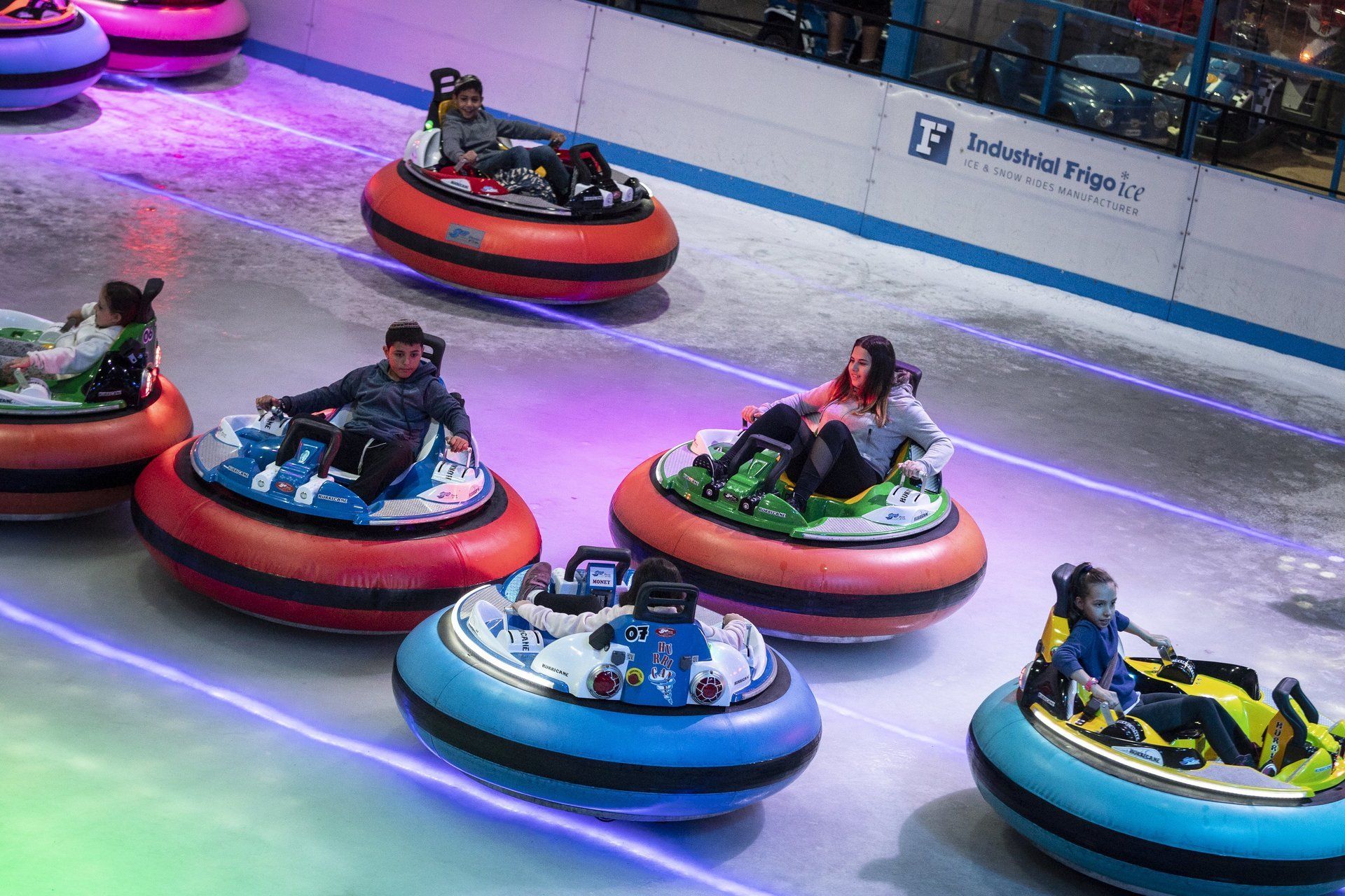 Multi coloured bumper cars on an ice rink