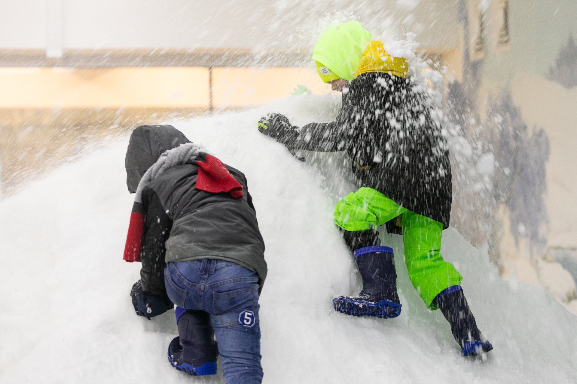 Kids playing on a snow heap