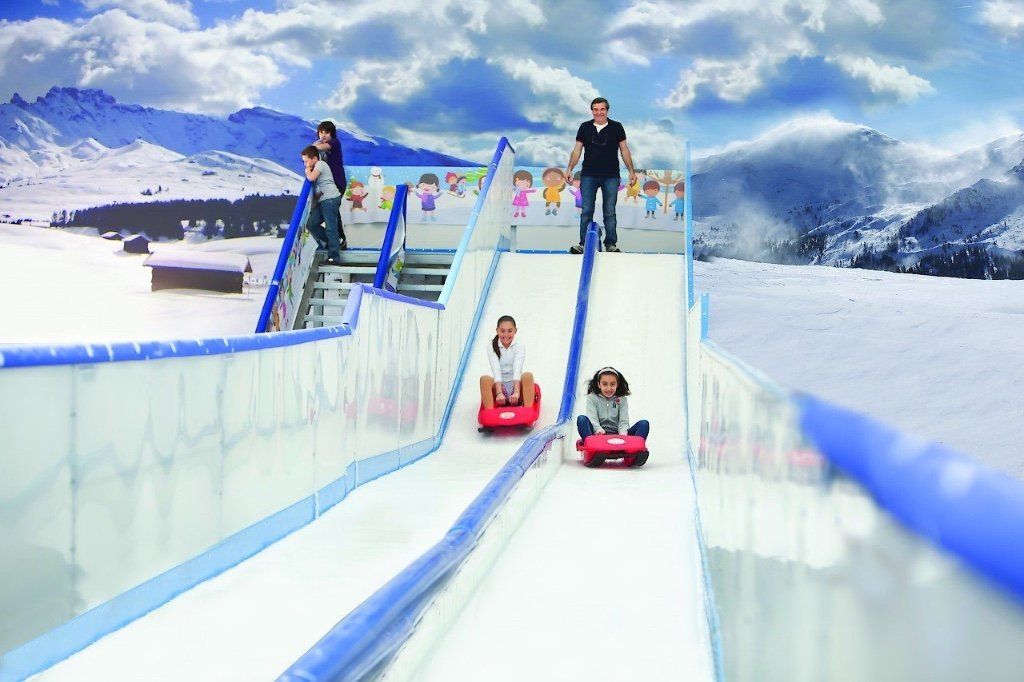 Mini ice slide with riders coming down