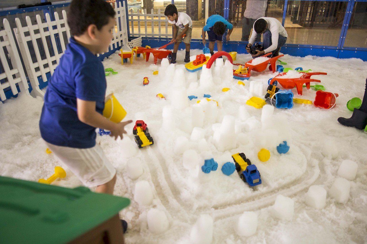 Children playing inside a Snow Playbox enclosure