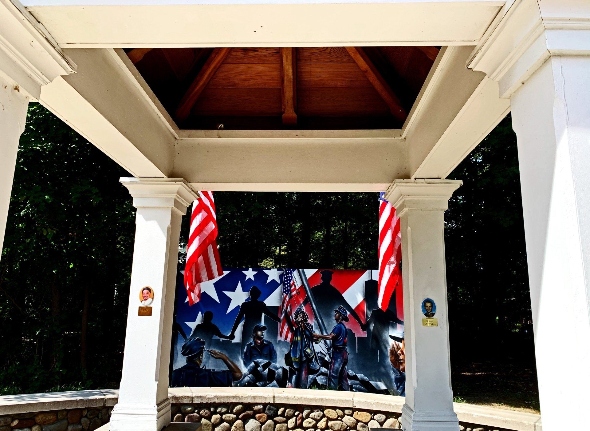 A 9/11 memorial. An image of an American flag next to a painting.