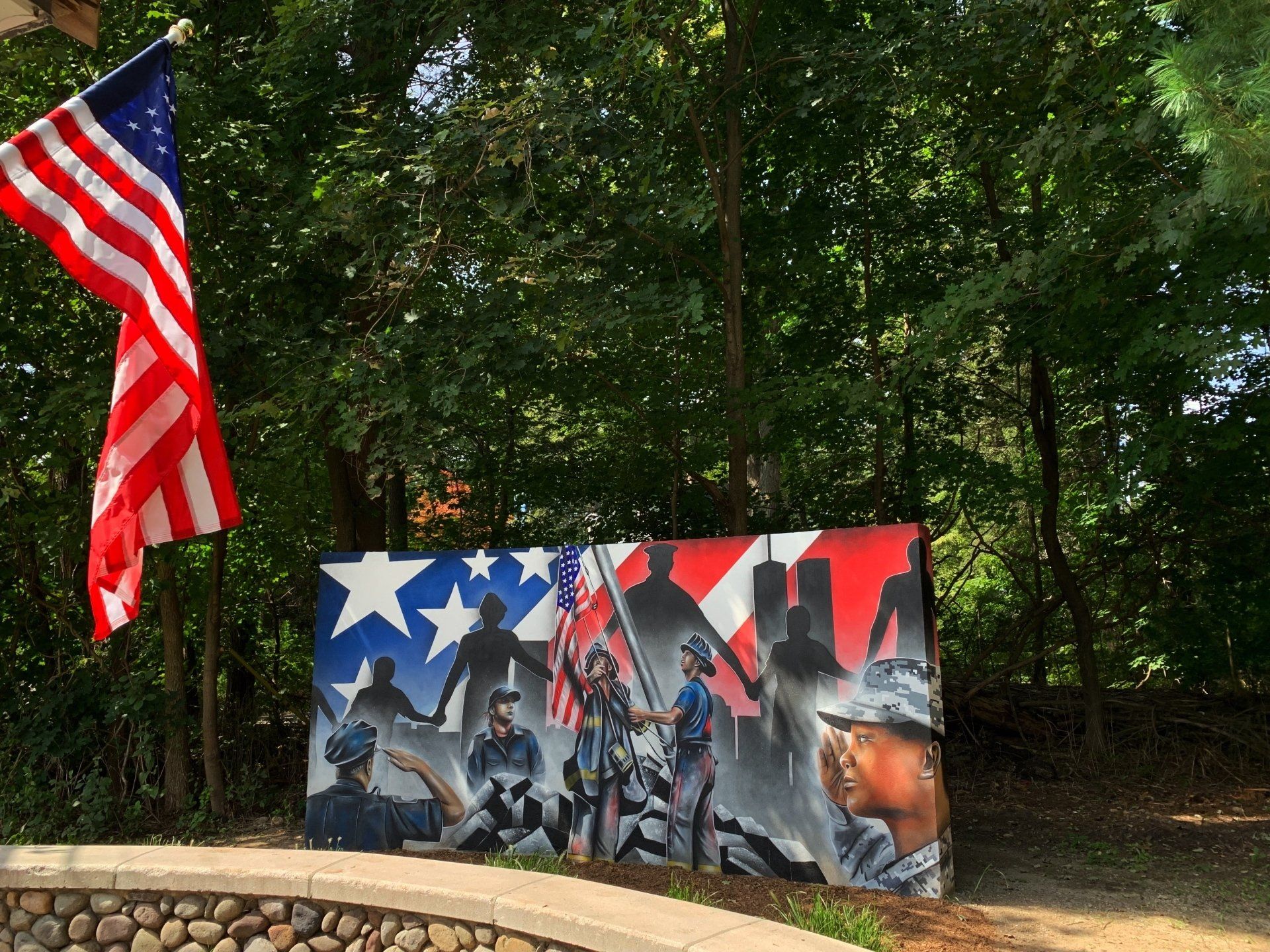 A 9/11 memorial. An image of an American flag next to a painting.