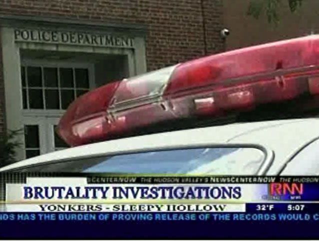 An image of a police car outside a police station.