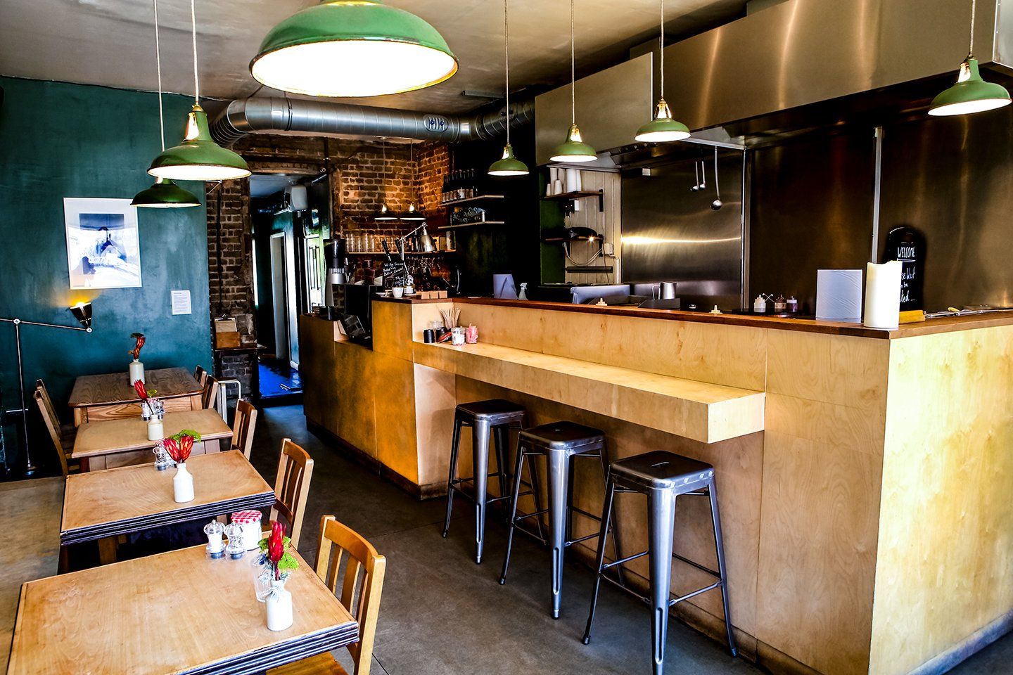 Photo of interior of Le Merlin Bar in Clapton showing tables and kitchen