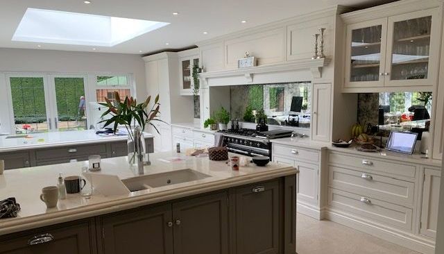 Elegant open-plan kitchen featuring bespoke cabinetry, central island, and large skylight — a premium interior renovation by Richard Norton Construction, specialists in custom kitchens across Kent and the South East.