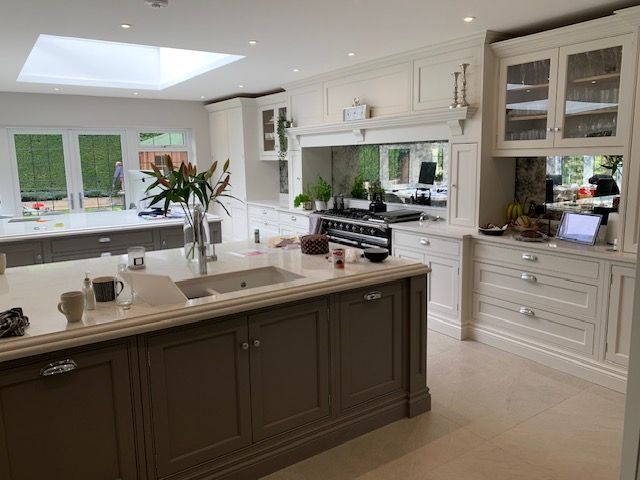 Elegant open-plan kitchen featuring bespoke cabinetry, central island, and large skylight — a premium interior renovation by Richard Norton Construction, specialists in custom kitchens across Kent and the South East.