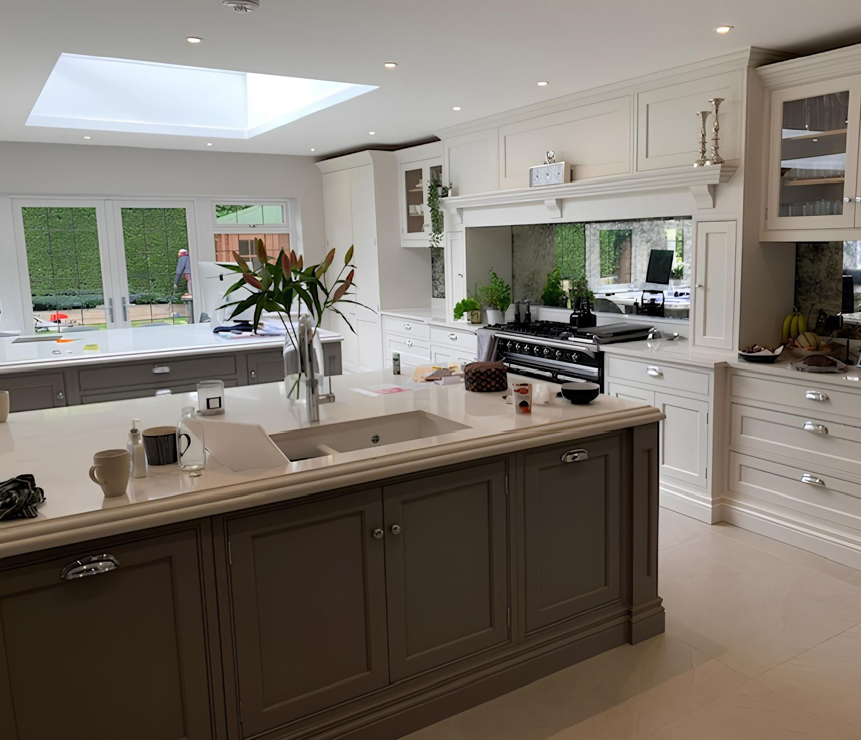 Elegant open-plan kitchen featuring bespoke cabinetry, central island, and large skylight — a premium interior renovation by Richard Norton Construction, specialists in custom kitchens across Kent and the South East.