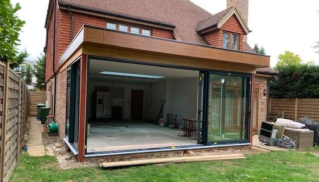 Small Extensions and Loft Extensions Sleek contemporary home extension with full-width bifold doors and flat roof skylight, built by Richard Norton Construction — specialists in modern open-plan living solutions across Bromley and North Kent.