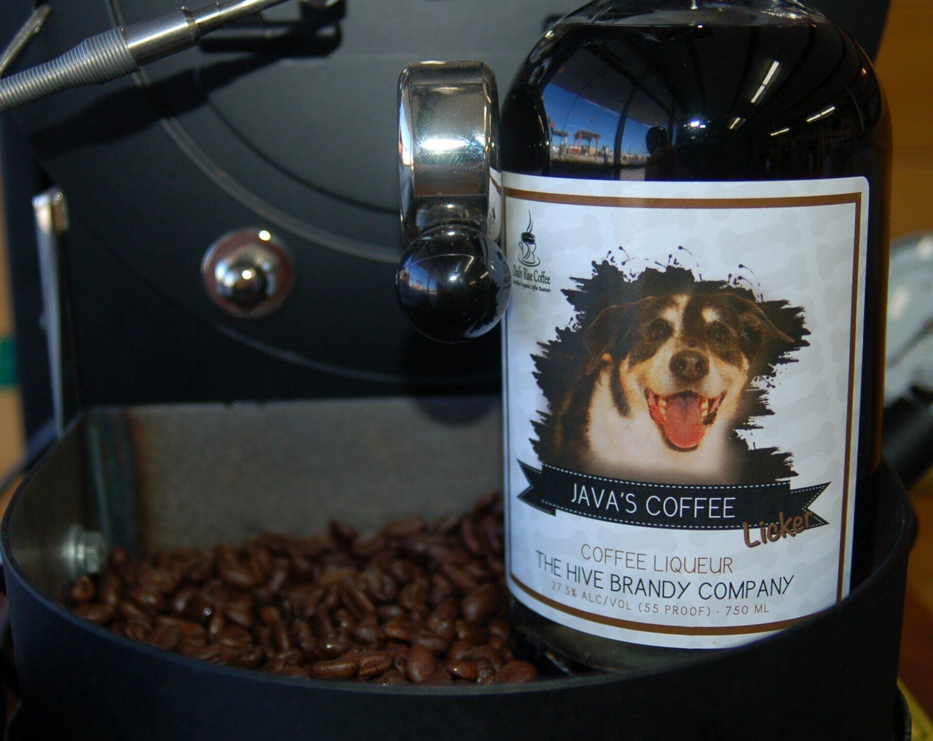 Java's Coffee Licker, coffee liqueur sitting on a coffee roaster with coffee beans.