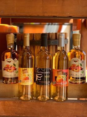 Collection of peach products. Includes Liquid Sunshine Peach Wine, Desert Sunset Dry Oaked Peach Wine, Peach Honey Wine, Peach Brandy on French Oak and Peach Brandy on American Oak