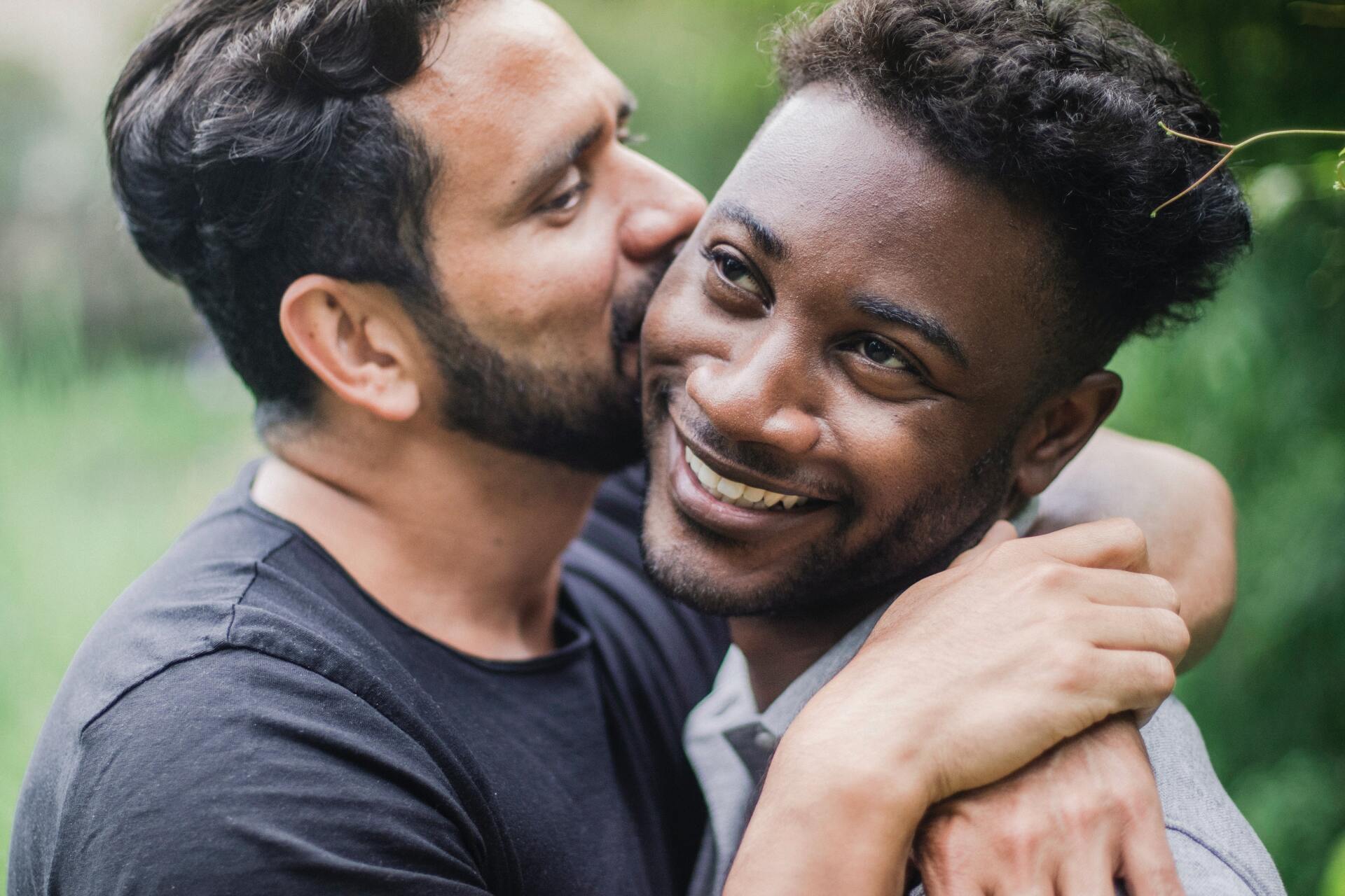 Gay couple sitting in their home
