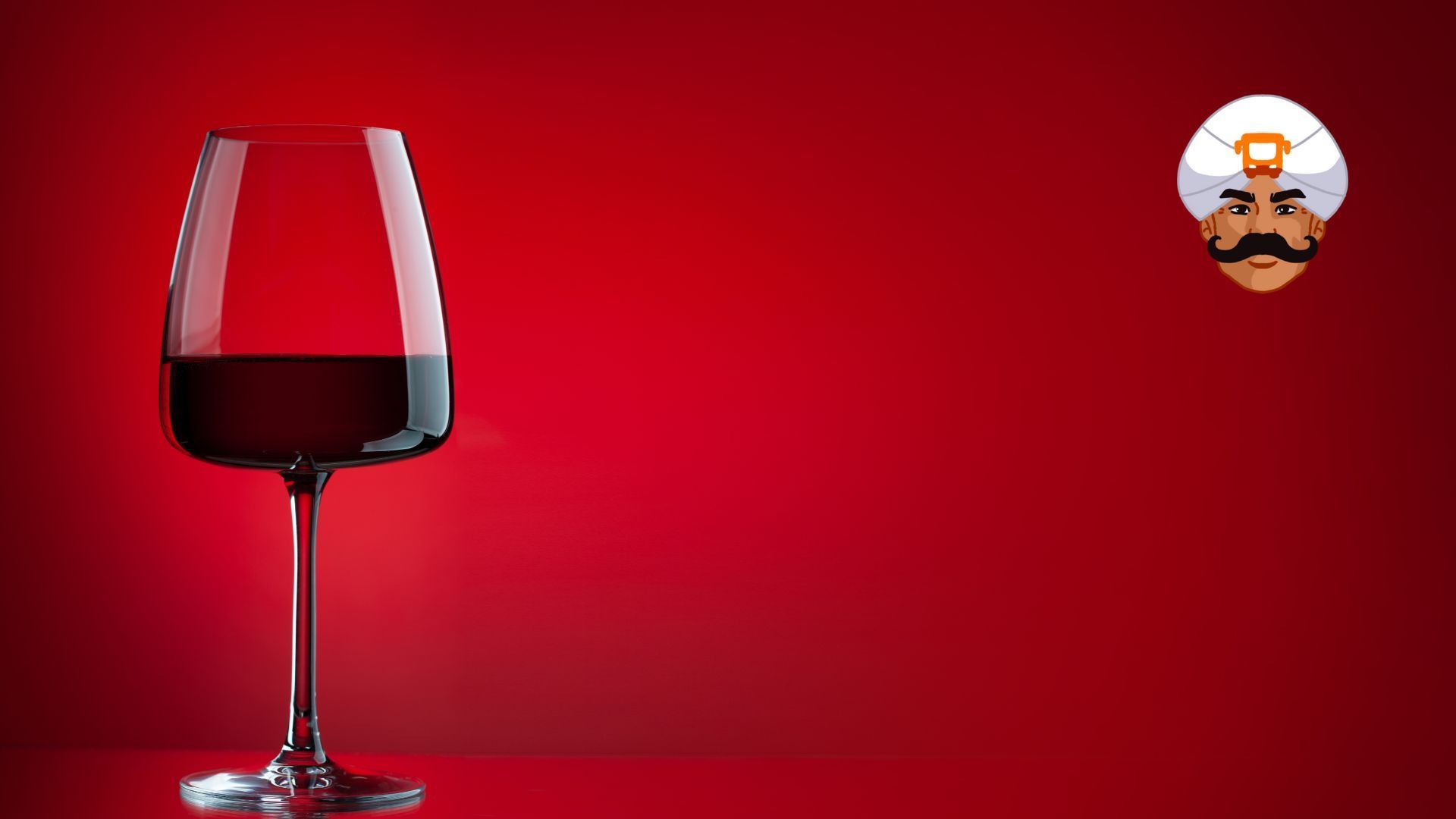 Calice di vino nero su sfondo rosso