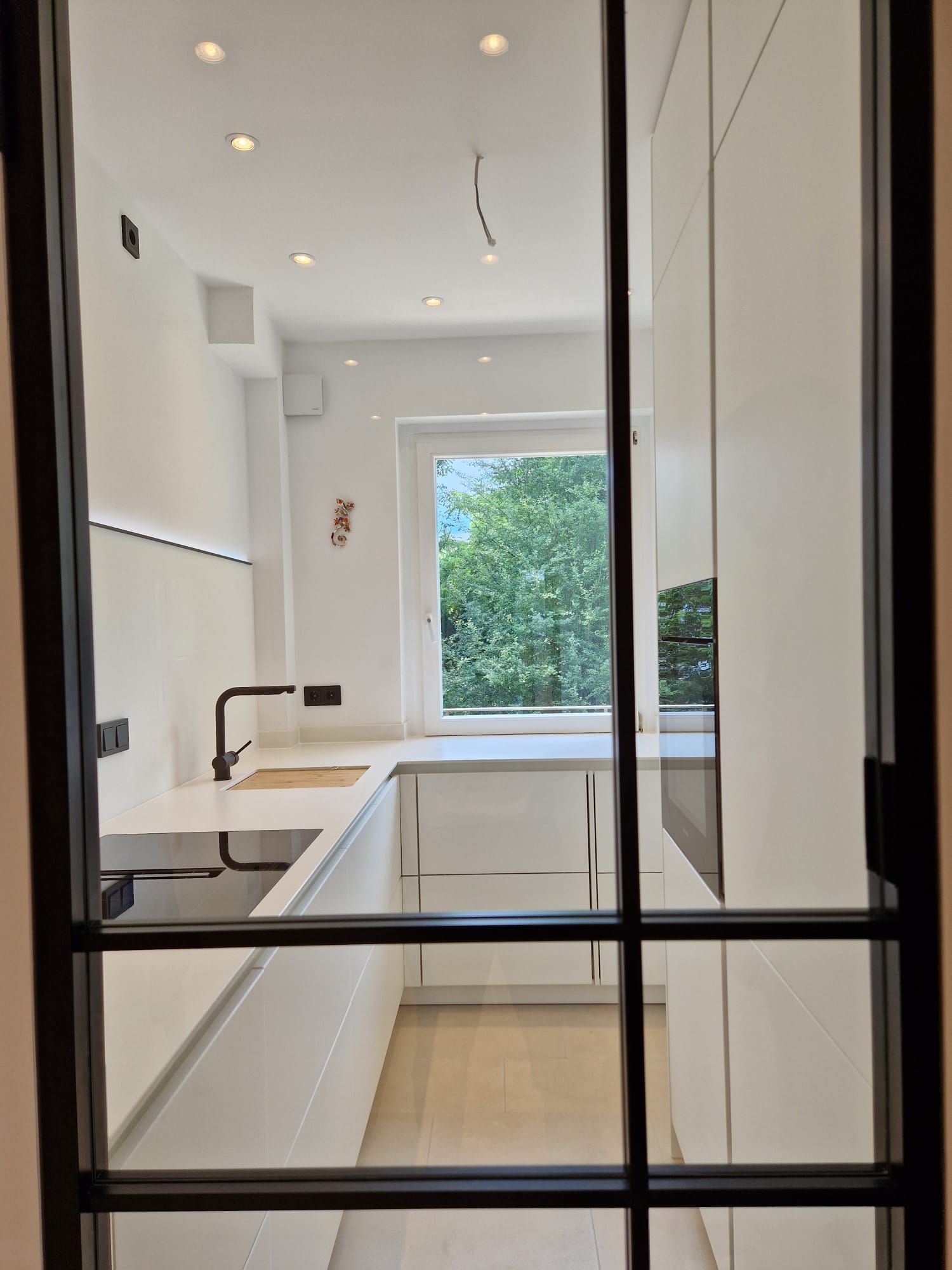 Moderne Schwarz-Weiß Küche in Frankfurt: Ballerina Smartglasfronten, Blackline-Griffmulden