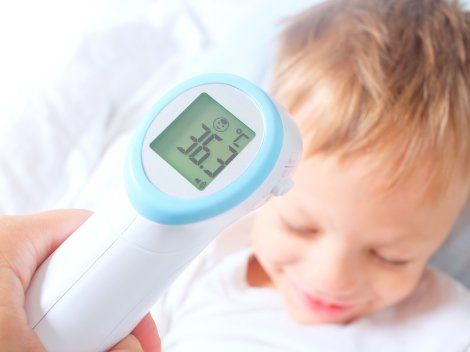 forehead thermometer with little child-baby