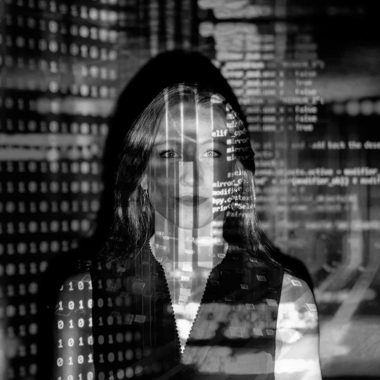 Frau steht vor Projektionsfläche mit Programmcode