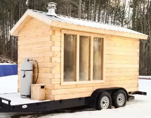 Outdoor sauna with steamy windows heated by propane sauna heater