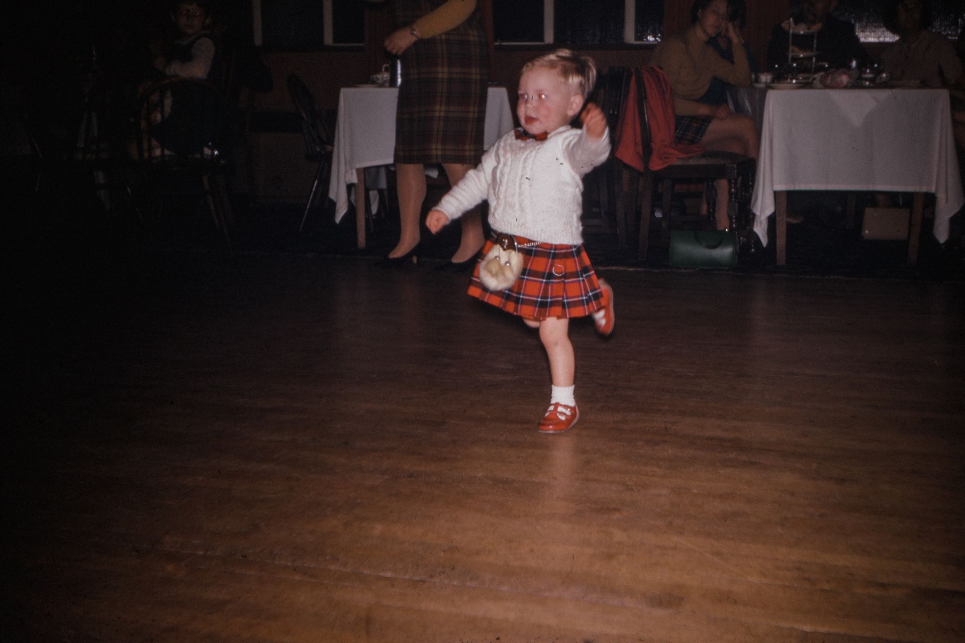 Young child in kilt on dance floor