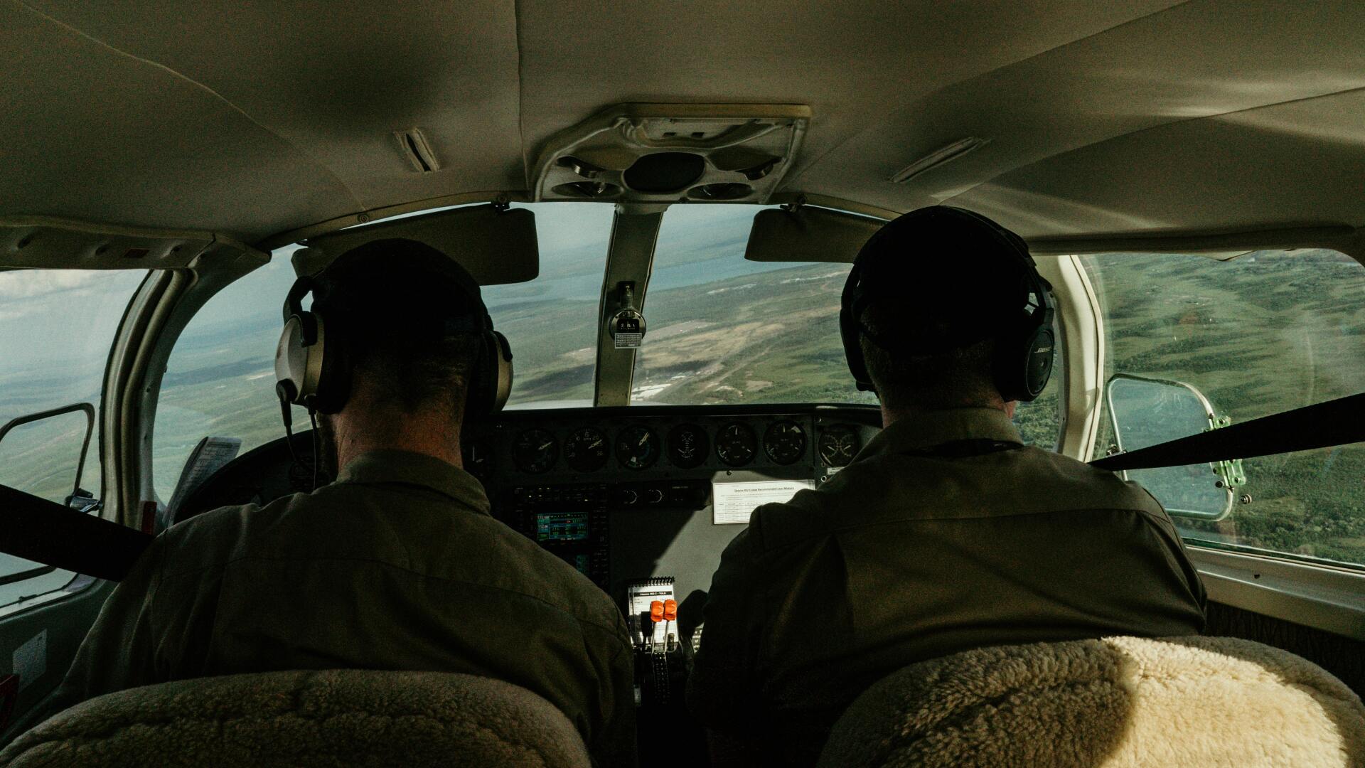 Two people in light aircraft cockpit