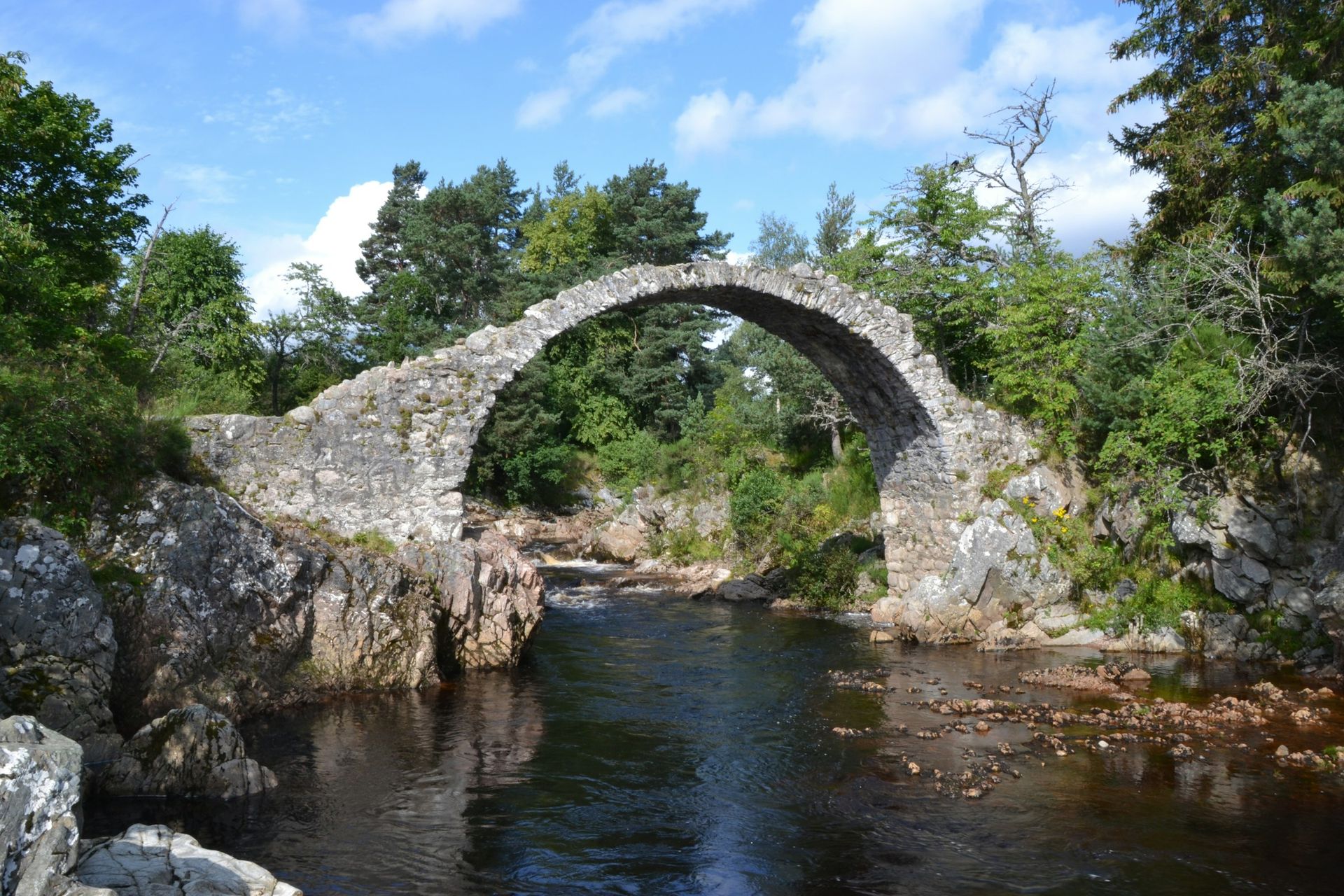 Only £6.99 Order Yours Today Old stone packhorse bridge over river reflecting bridge in water