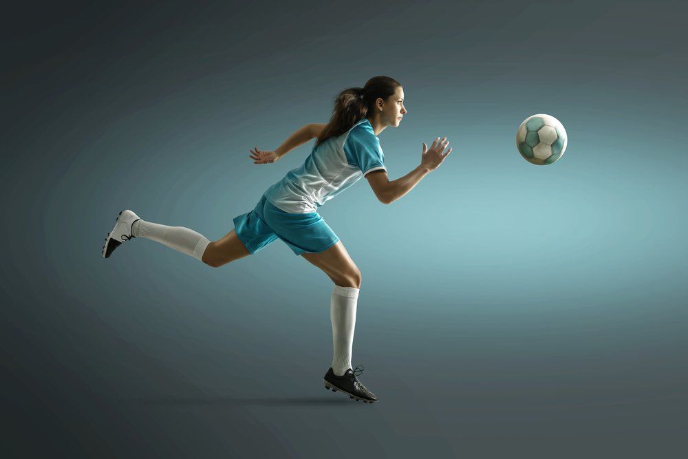 Woman playing soccer football