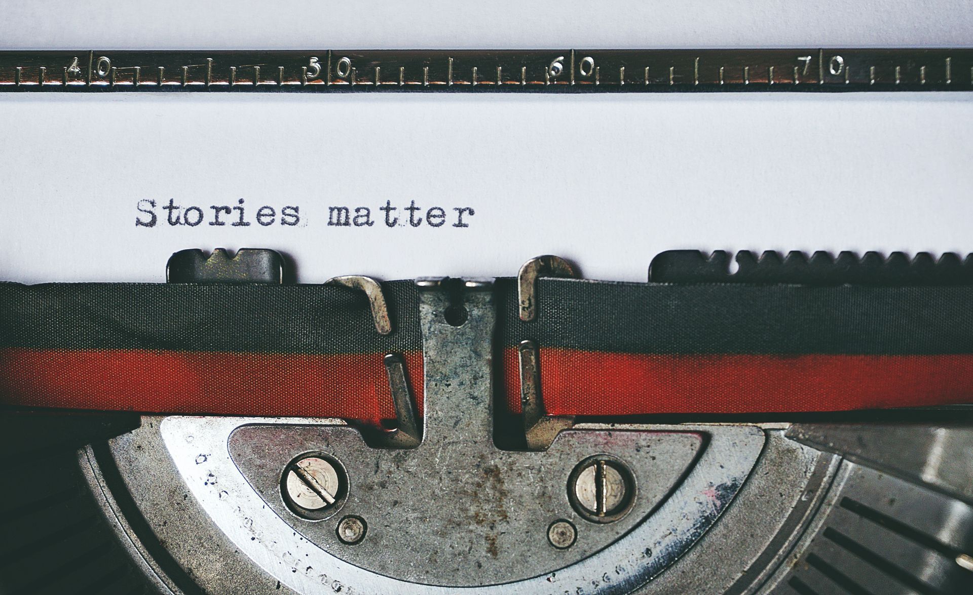 Old typewriter with the words 'stories matter' typed on the sheet of paper
