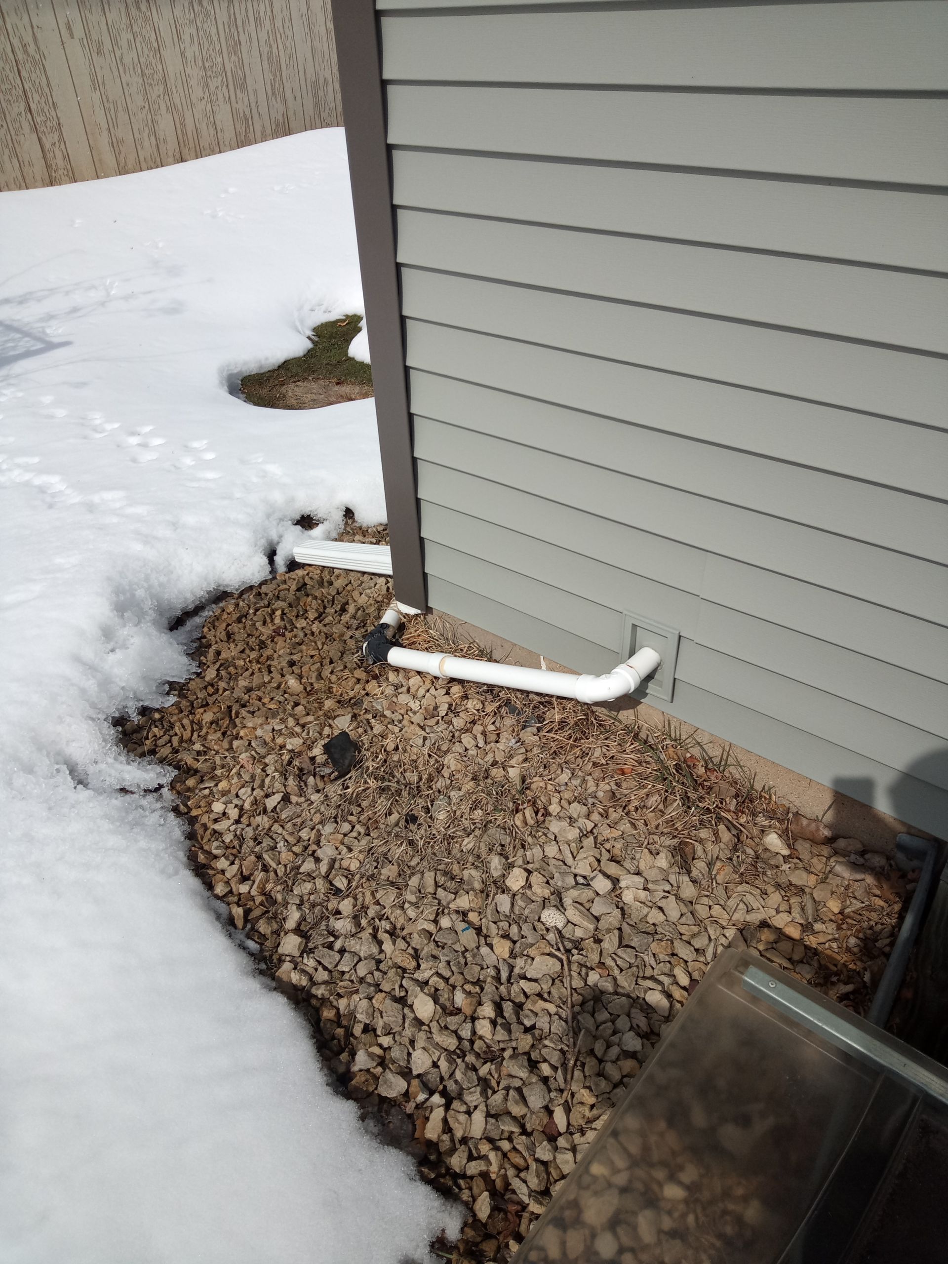 Drain Tile Discharge is draining next to foundation crack.