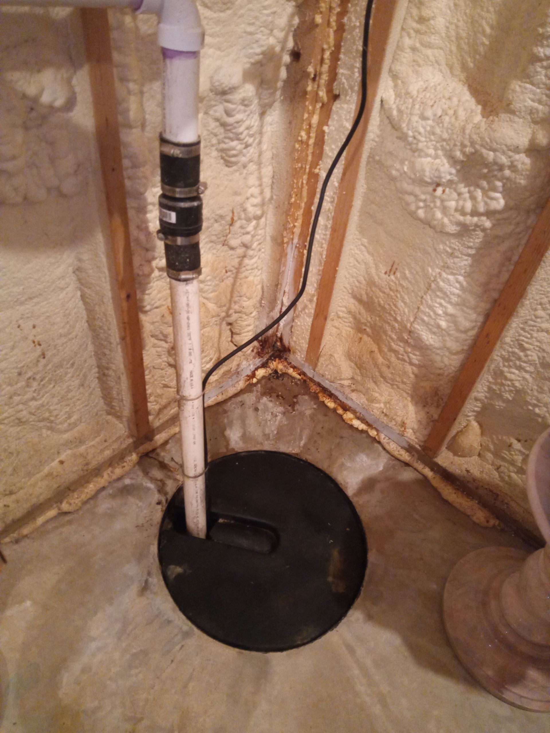 Leaking basement with spray foam walls.