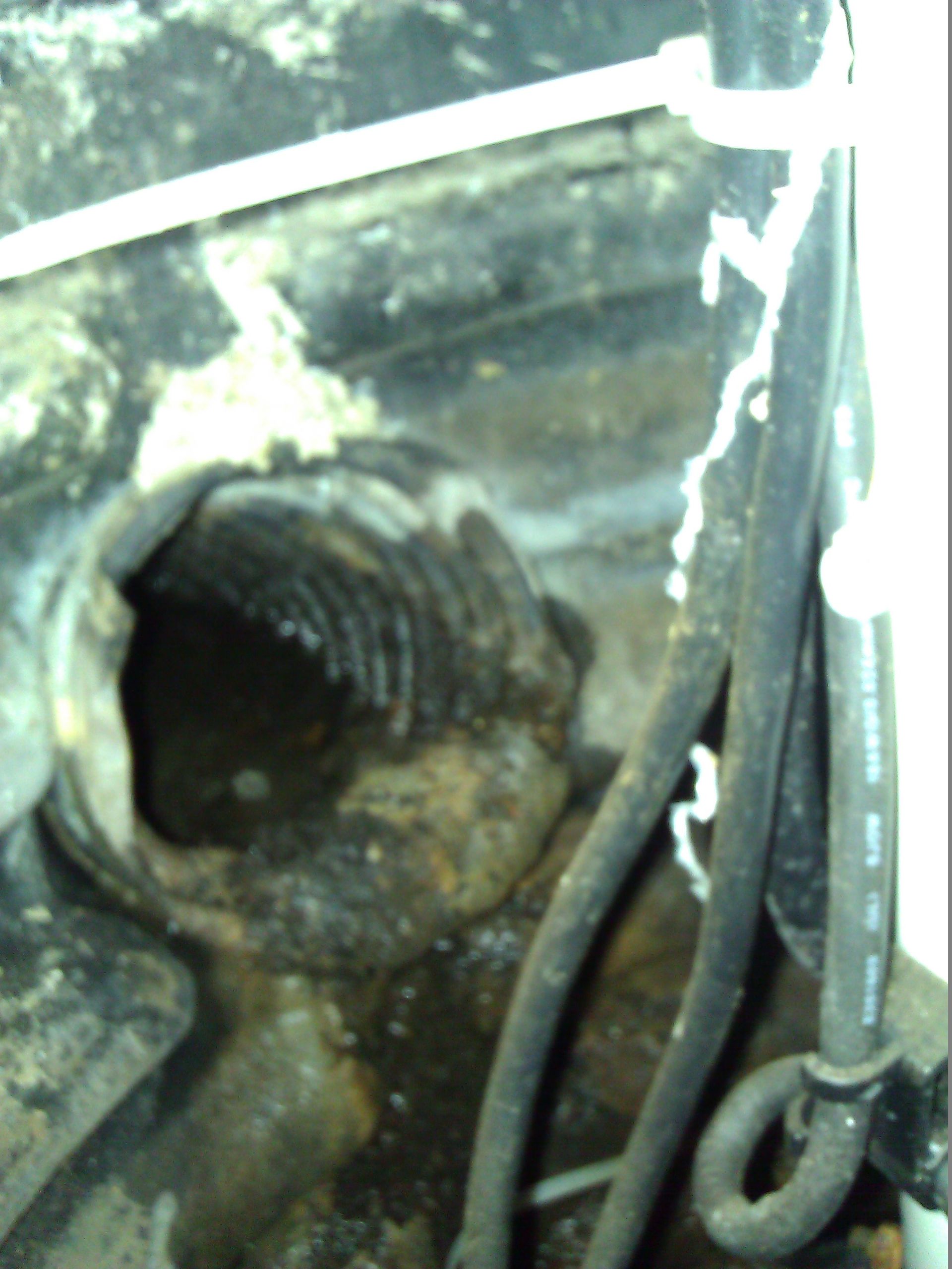 Drain tile pipe clogged up with mineral crust