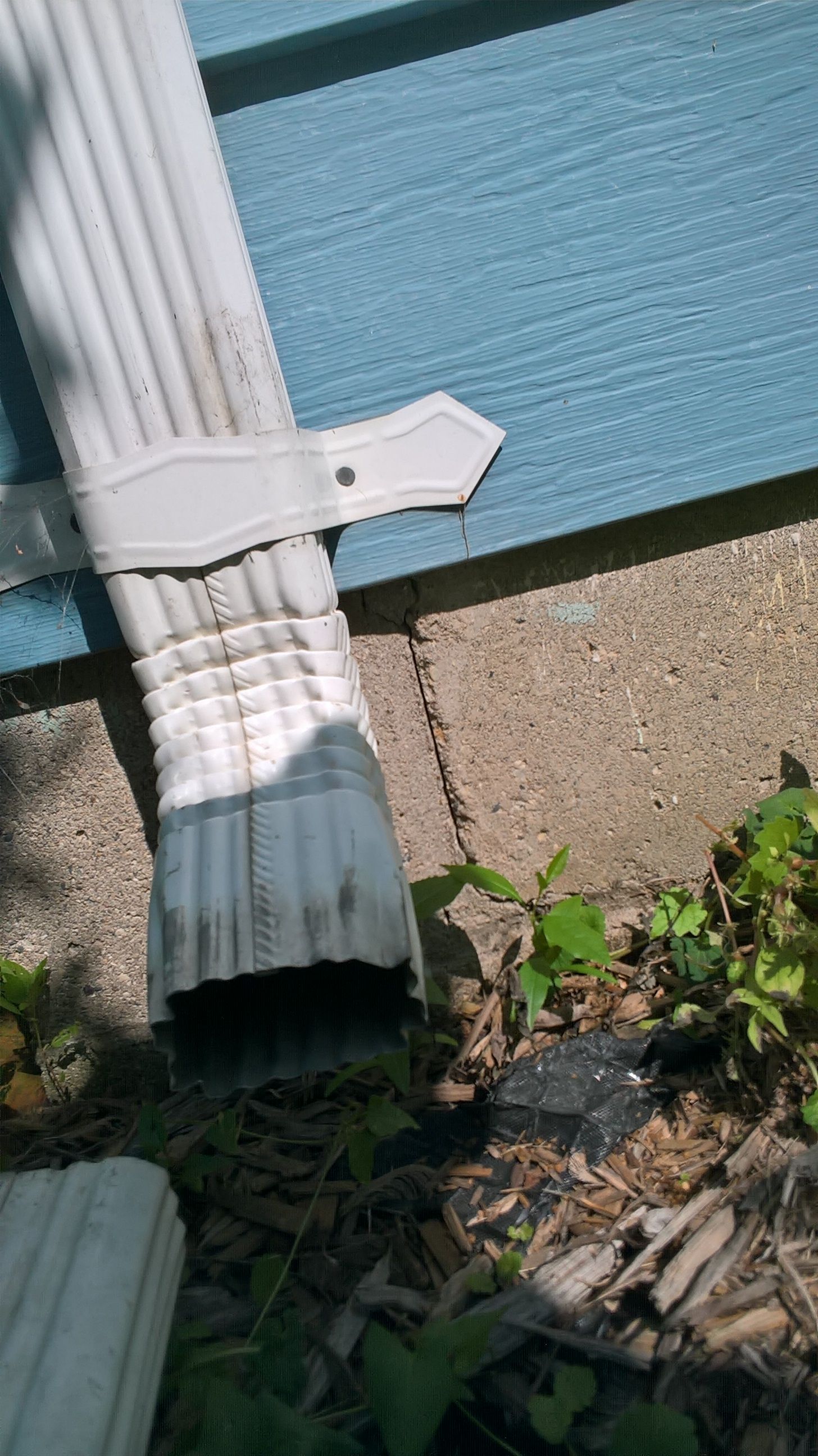 Wet basement with stair step crack