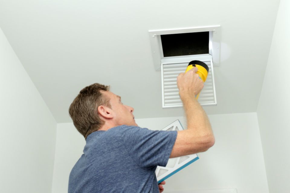 Inspector checking air vent