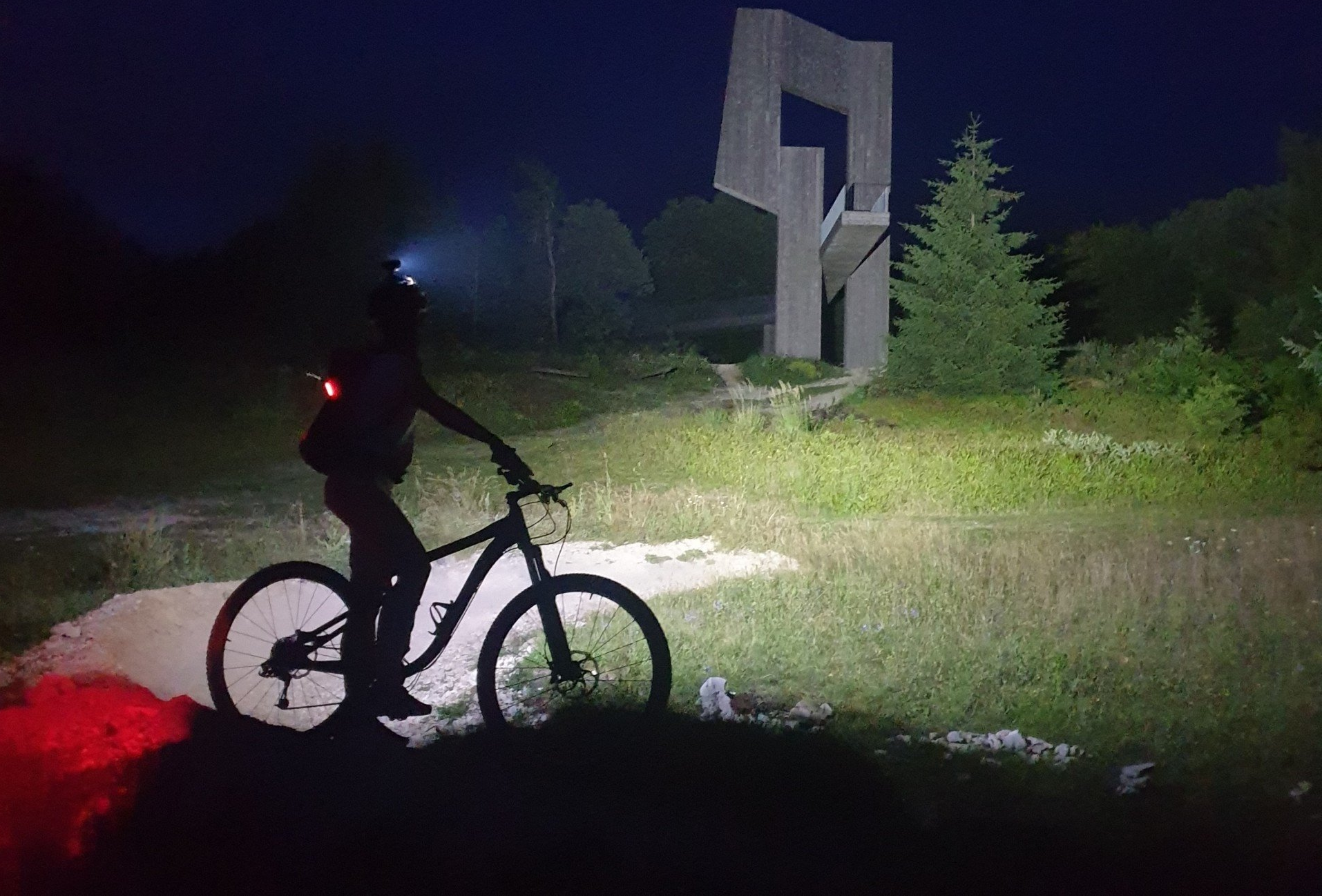 Magicshine Helmlampe Monteer 6500 mit 6 Leuchten bei Sonnenuntergang im Wald und auf der Wiese mit dem Fahrrad oder Mountainbike, offroad inklusive Rücklicht des Fahrradfahrers SeeMee 180