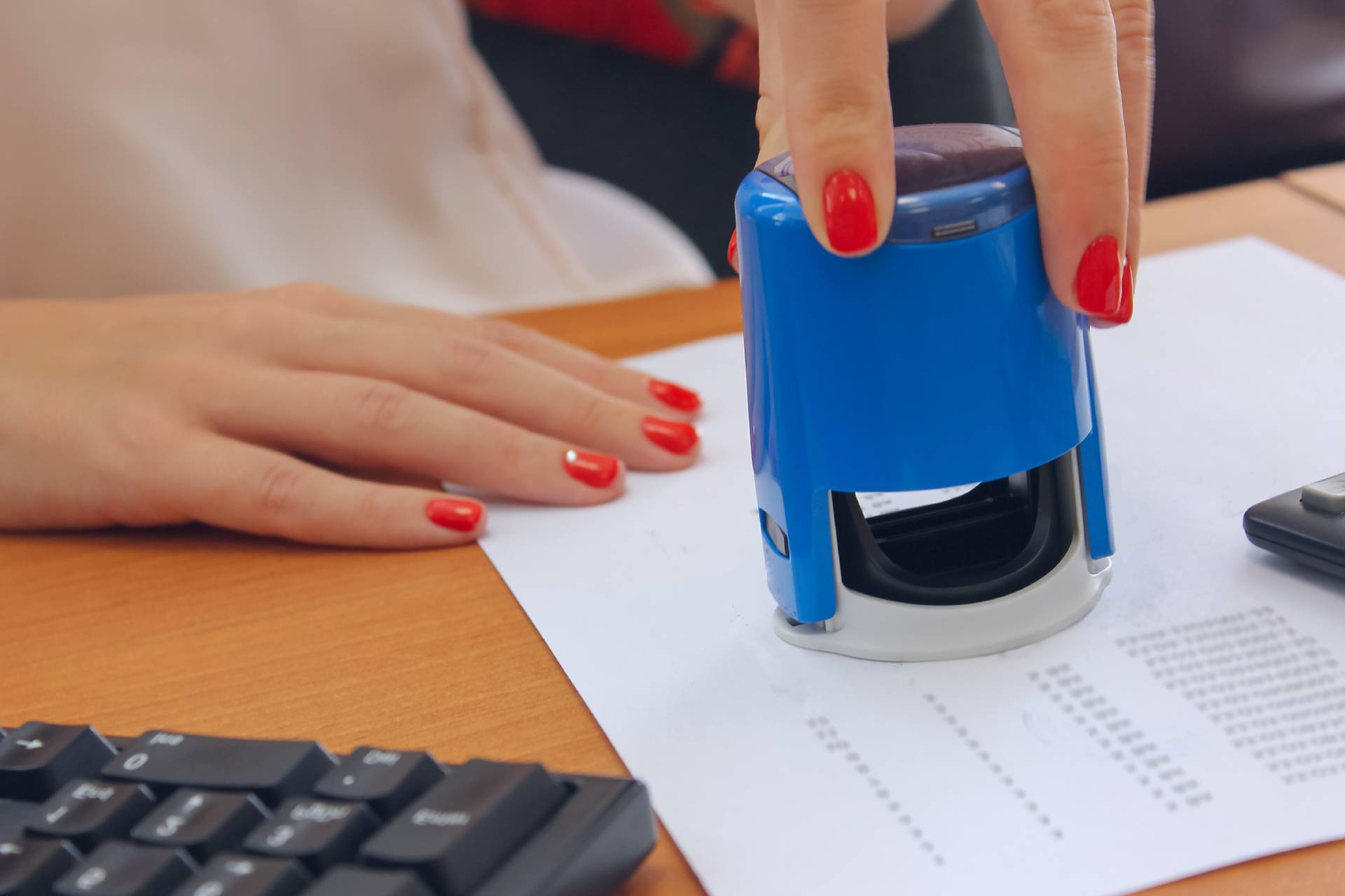 a person stamping a document
