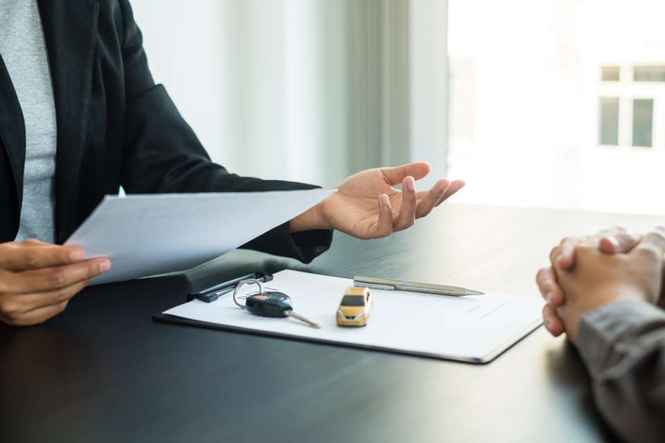 two people at a desk overlooking documents