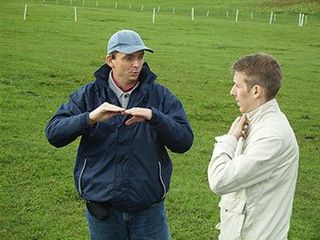 Photo of international consultant Guido Haas talking to organic farm investor in Romania.