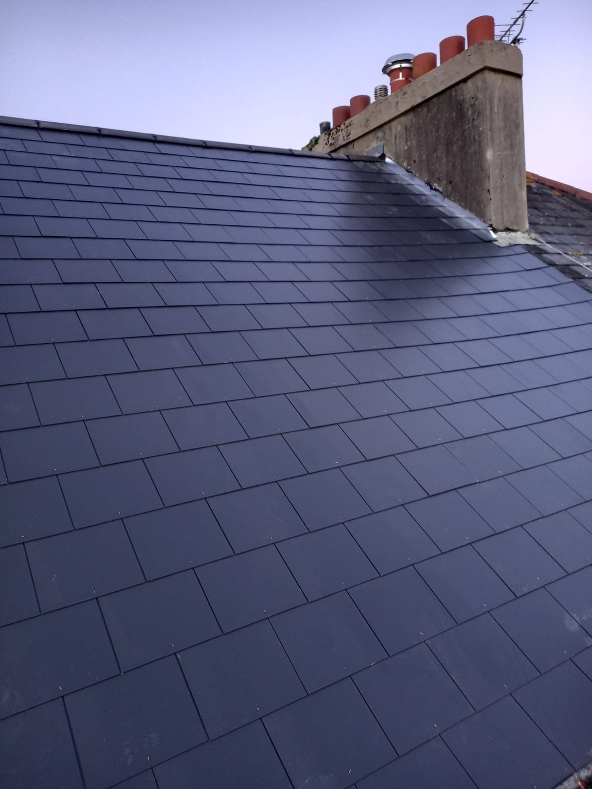 Finished roof replacement featuring new ridge tiles in Ashburton