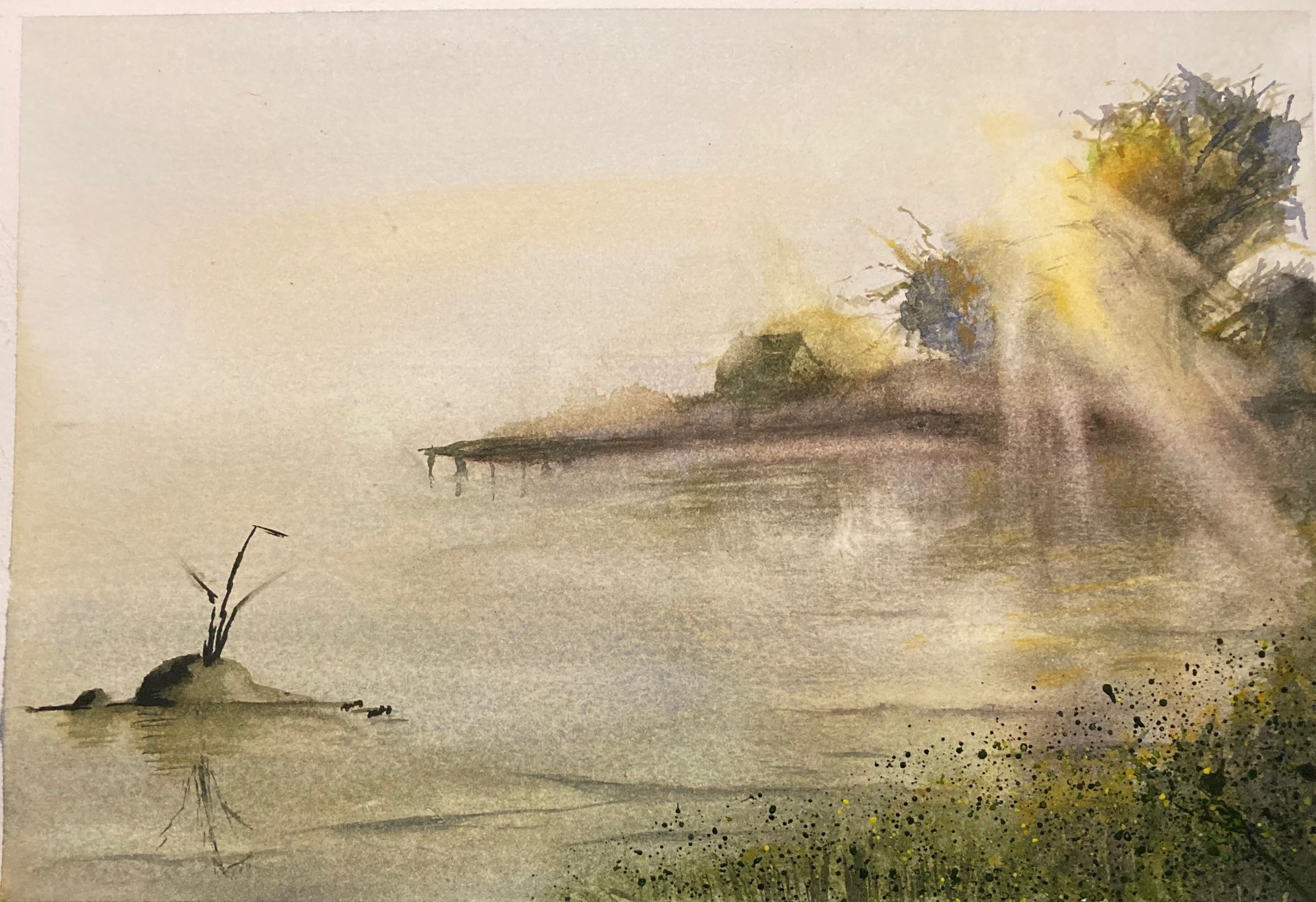 Misty morning lake scene, with light breaking though the trees