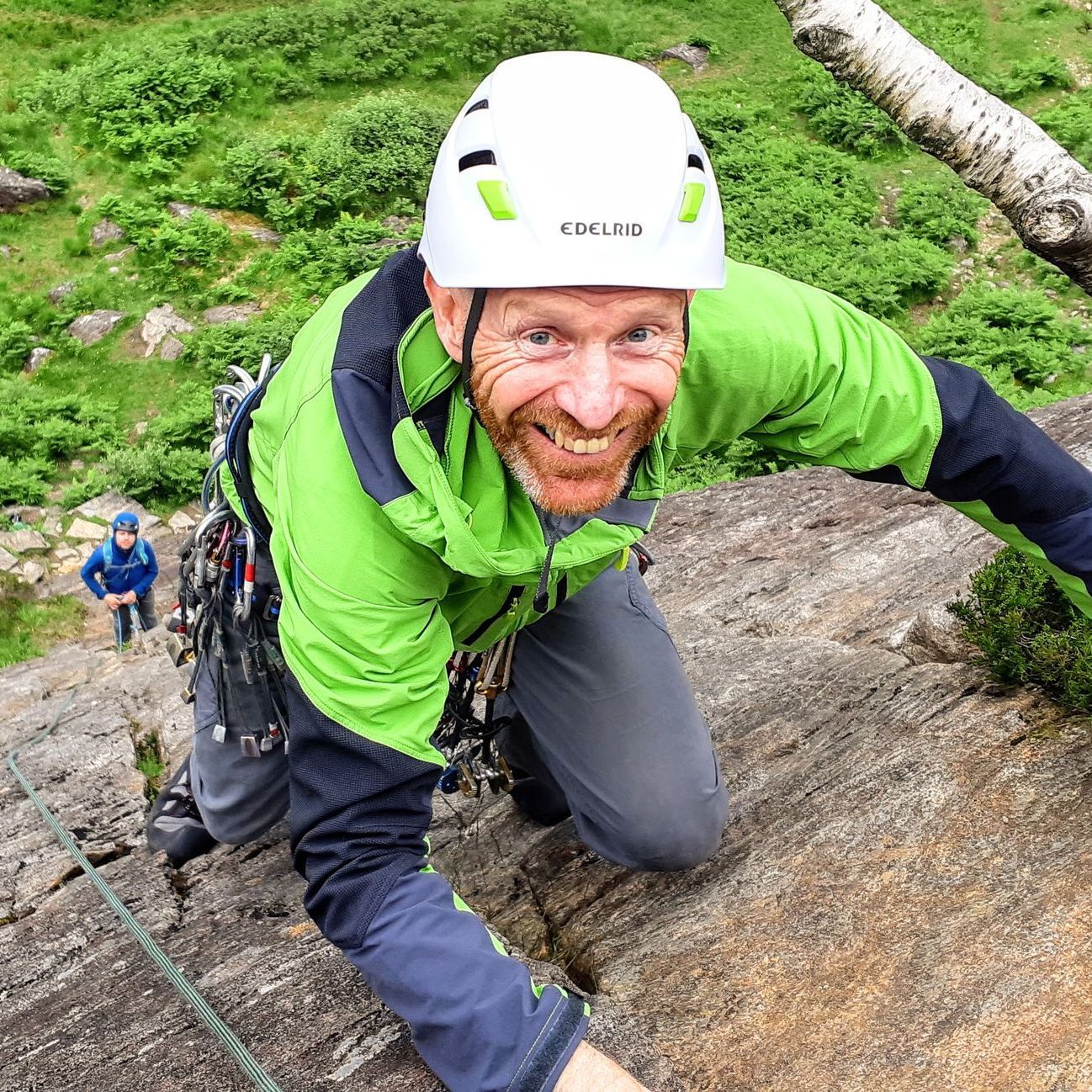 Learn to lead Rock climbing courses - A man in Green laerning to lead climb on the Gutter in Polldubh