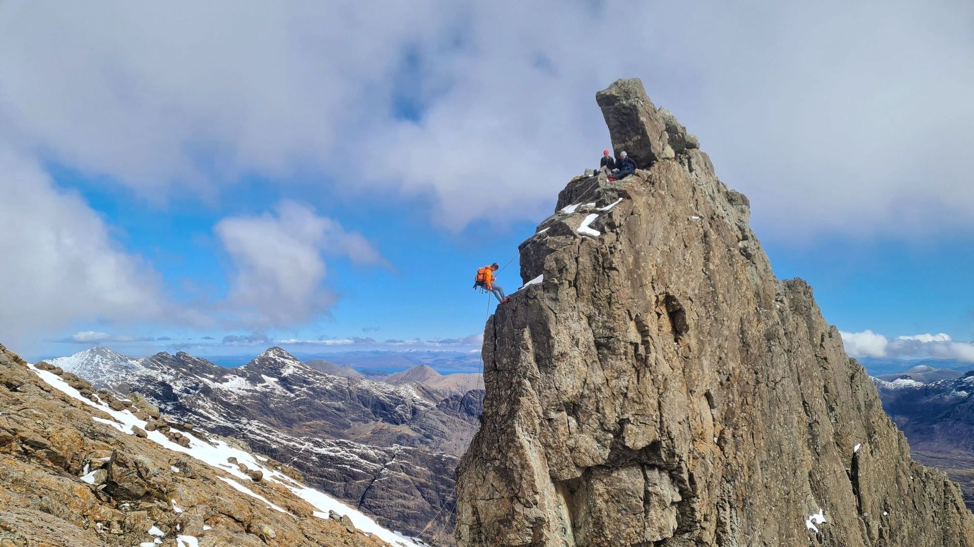 A climber abseiling off the In Pinn on the Skye Cuillin Ridge. Skye Cuillin Ridge Traverse Guides or Cuillin Munro Guides