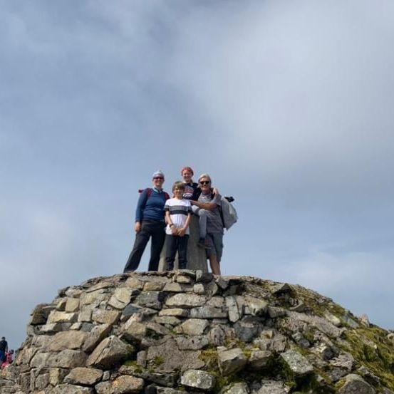 Stood at the Summit of Ben Nevis on a sunny day. Having made the summit with Ben Nevis Guides from Elite Guides