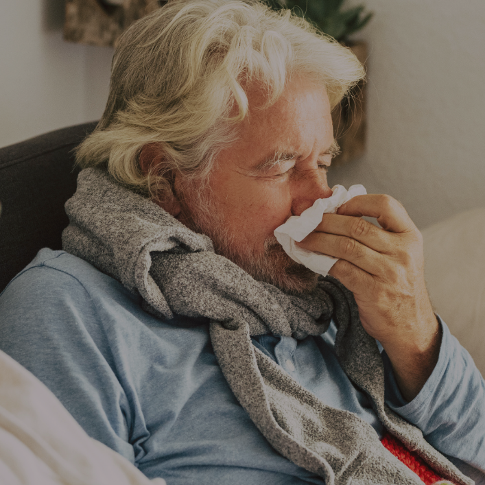 man blowing nose