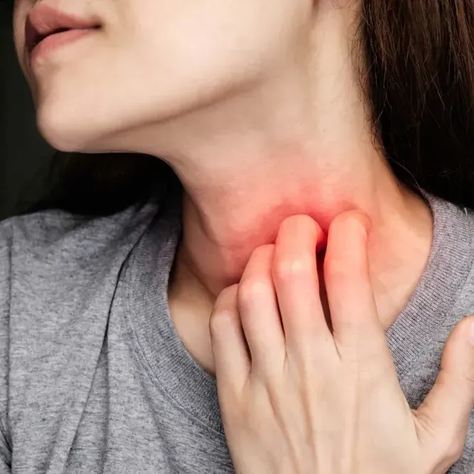 woman scratching neck