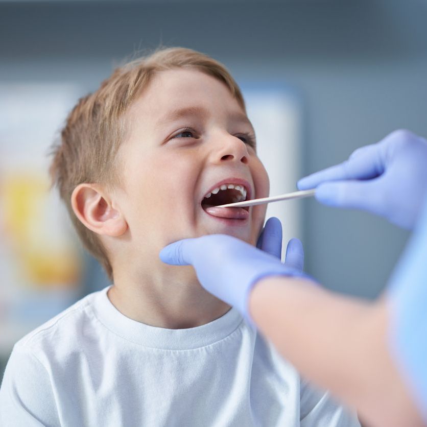 doctor looking in boys mouth