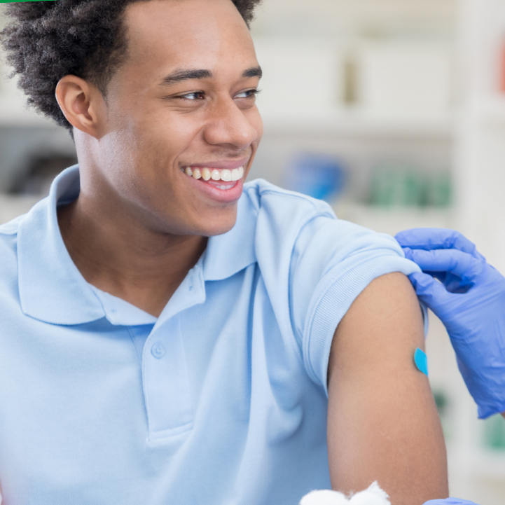 man smiling after receiving a vaccination