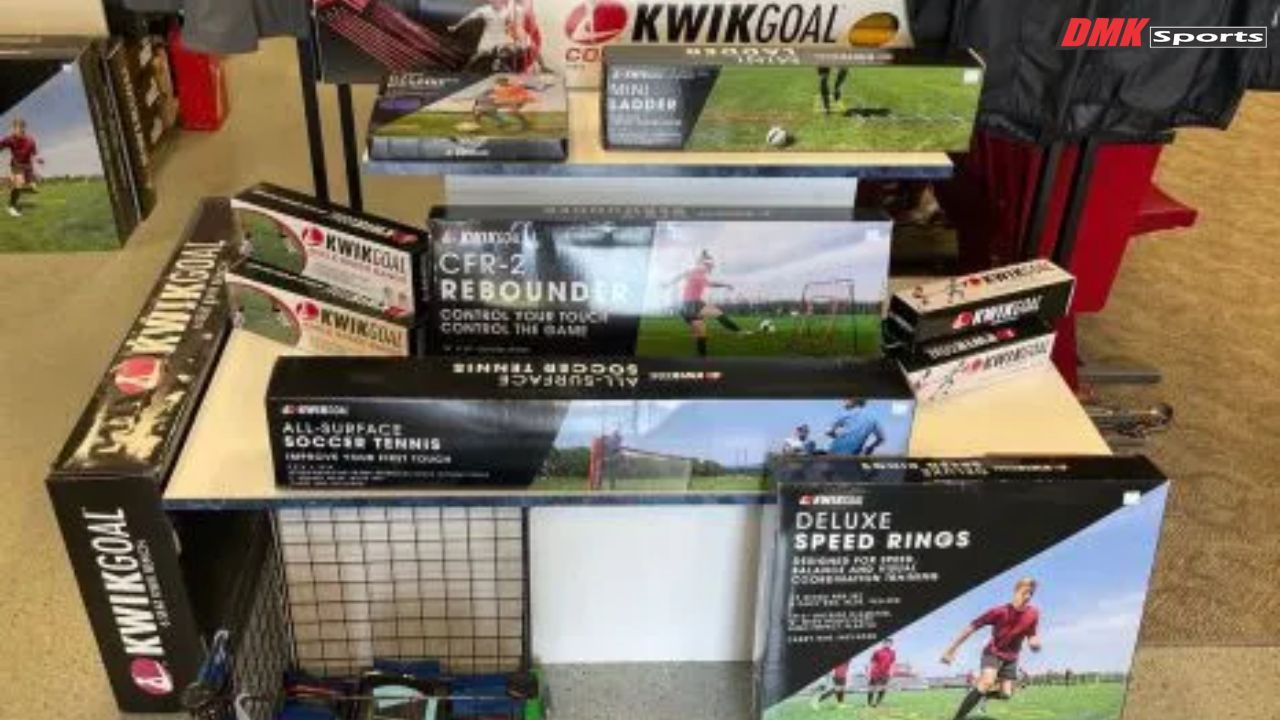 Wall display of assorted goalkeeper gloves in various colors and brands hanging in DMK sports store