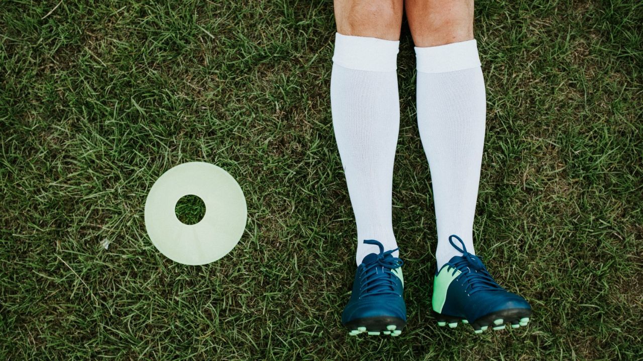 Soccer player wearing white grip socks and cleats