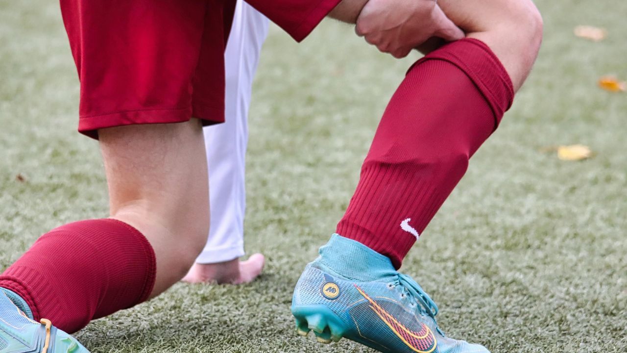 Soccer player experiencing a ham injury during match play