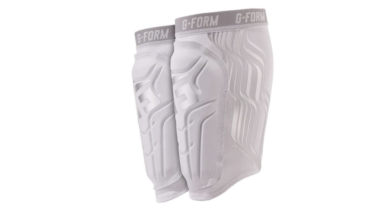Soccer shin guards with impact-absorbing padding designed to protect shins from tackles and kicks.
