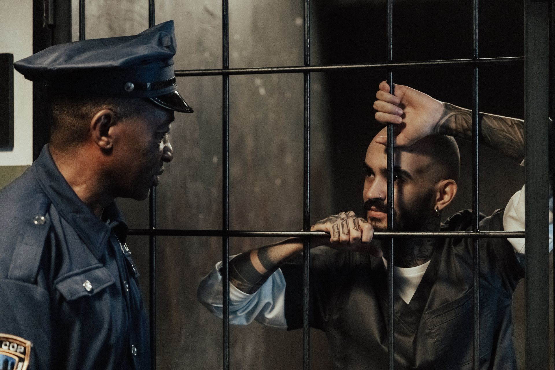 cop talking to inmate behind bars
